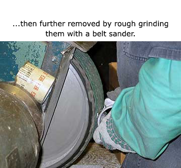 Gates and risers are further removed by rough grinding with a belt sander